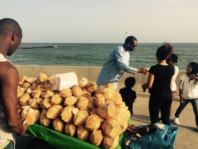 Youssou Ndour et ses enfants en train de boire l'eau de coco non loin de l'embarcadère de Gorée