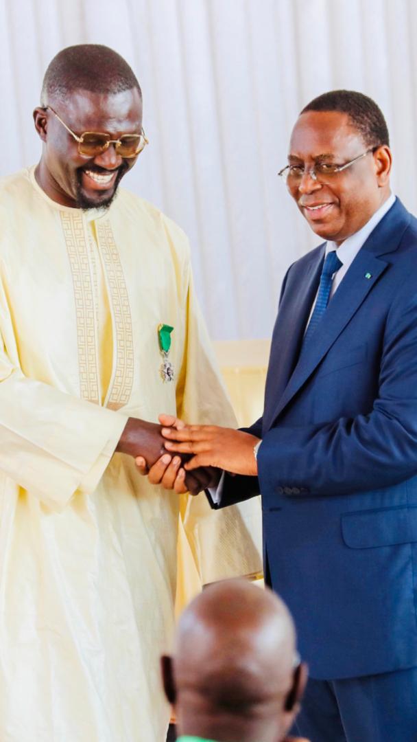 Moustapha DIeng, PCA du FDCUIC, co-fondateur de la Marmite du Coeur et PDG de Sen'Art Vision est élevé au grade de Chevalier de l'Ordre National du Lion. Moustapha DIeng, PCA du FDCUIC, co-fondateur de la Marmite du Coeur et PDG de Sen'Art Vision est élevé au grade de Chevalier de l'Ordre National du Lion.