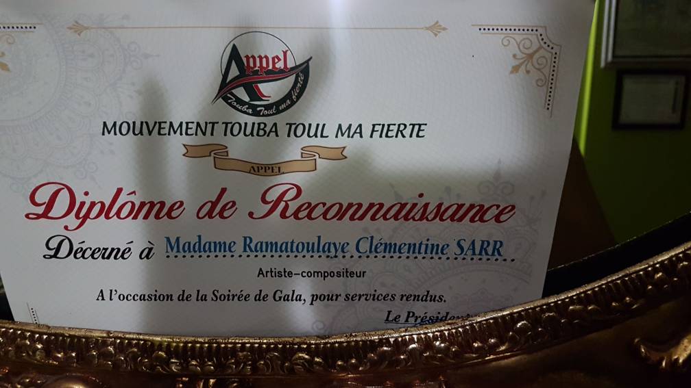TOUBAMA FIERTÉ: L'artiste Guigui reçoit son diplôme de reconnaissance;